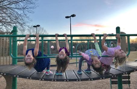 Four children playing on a playground