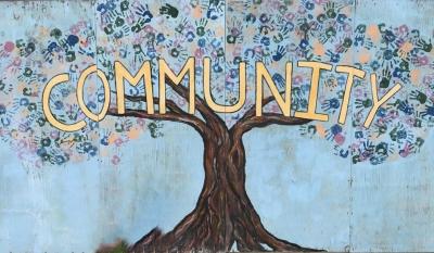 The word "Community" over a tree painting