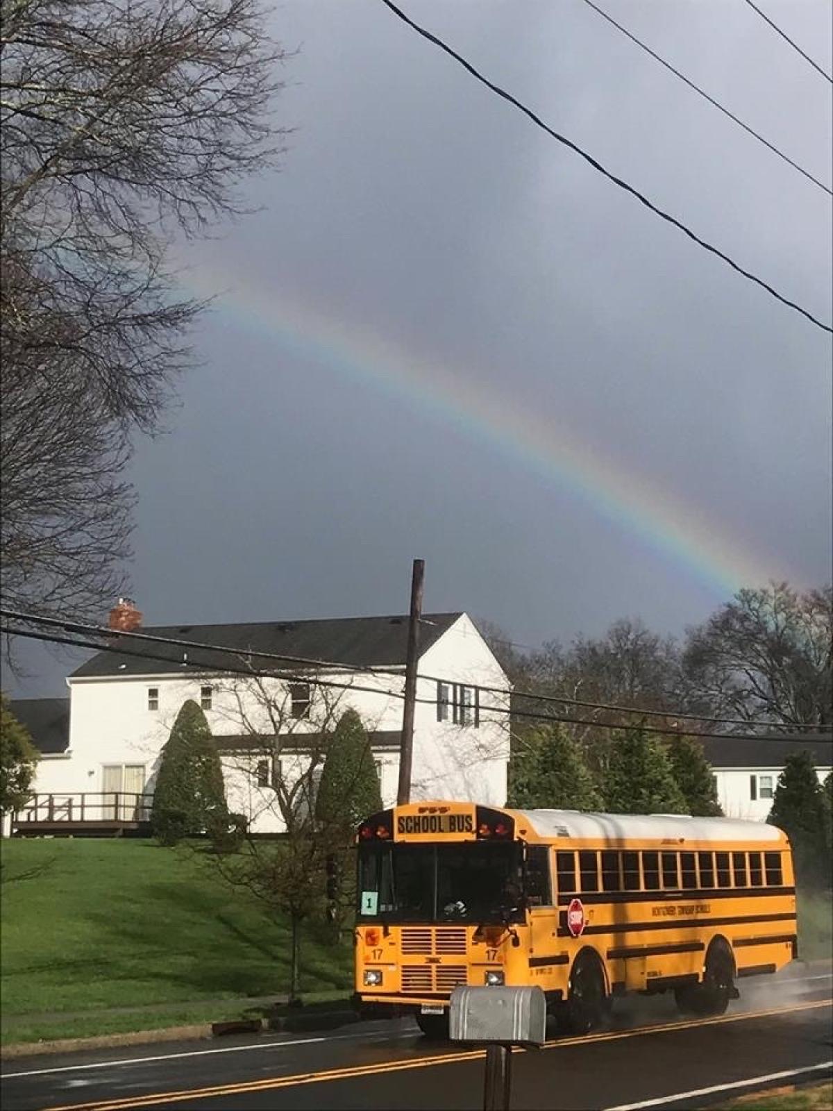 School Bus with a home and rainbow in the background